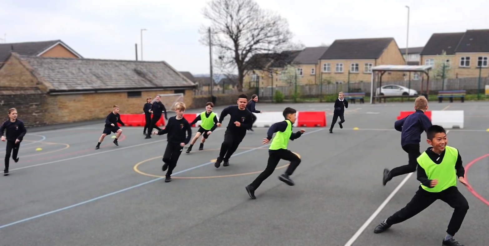 Children playing PE warm up games