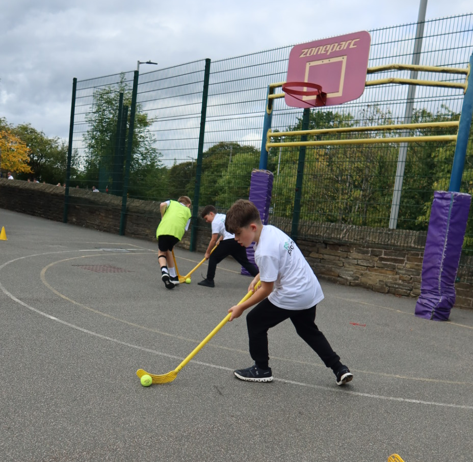 Boy in PE class playing Primary School Hockey